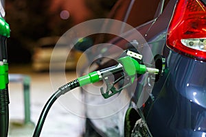 Car refueling on a petrol station in winter at night