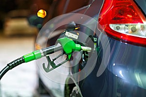 Car refueling on a petrol station in winter at night