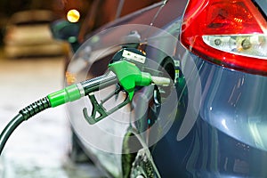 Car refueling on a petrol station in winter at night