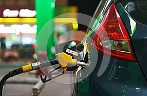 Car refueling on a petrol station in winter at night