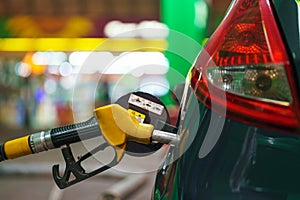 Car refueling on a petrol station in winter at night