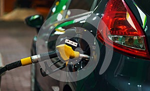 Car refueling on a petrol station in winter at night