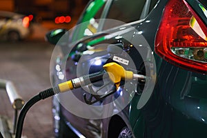 Car refueling on a petrol station in winter at night