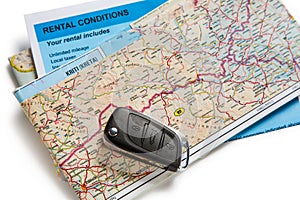 Car remote key, map and rental agreement