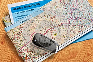 Car remote key, map and rental agreement