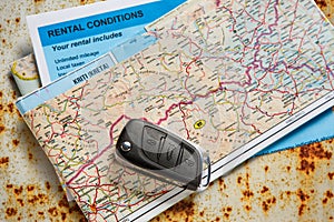 Car remote key, map and rental agreement