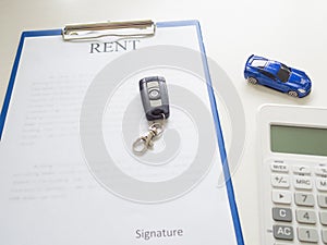 A car rent service lease contract with key and calculator