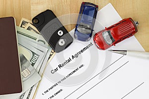 Car rental agreement with car key, passport, cash, credit card