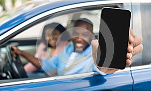 Car Rental App. Black Family Sitting In Auto Showing Blank Smartphone