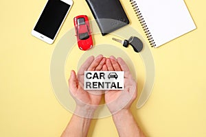 Car rental concept. Human hands holding text sign