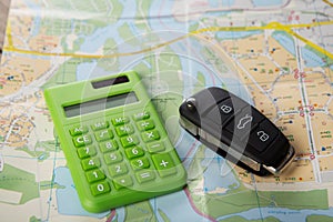 Car rental concept - car key and calc on the map photo