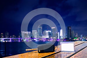 Car rental keys on wood table in Miami night