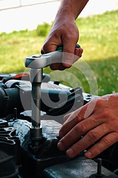 Car repair. Auto mechanic working on car engine in mechanics garage. Repair service. close-up shot