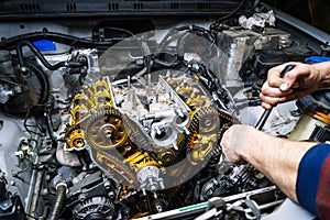 Car repair: overhaul of the V6 engine with detailed pulleys and parts. photo