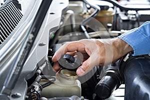Car repair service, Auto mechanic checking oil level
