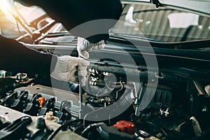 Car Repair service, Auto mechanic working in garage, Mechanic hands checking up of serviceability of the car in open hood, close photo