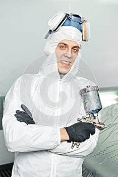 Car repairman painter in chamber