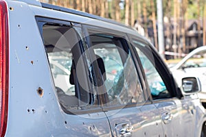 Car riddled with bullets. War of Russia against Ukraine. A car of civilians shot by the Russian military during the evacuation of