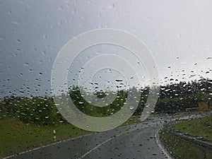 car ride in rainy weather at curvy road