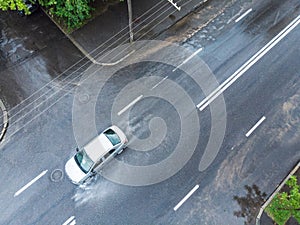 Car rides through flooded street. aerial photo