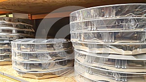 Car rims on store shelves. Waiting for a buyer. On wooden coasters. Various alloy wheels
