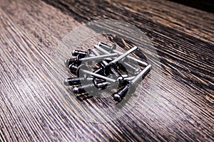 Car rivets on wooden background