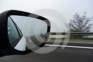 Car on the road with mirror reflection. Motion blur road