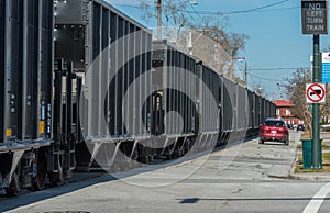 Car on road next to Coal Cars