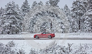 Car on the road, snowy countryside, cloudy sky