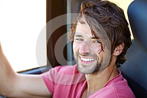 Car road trip, face portrait and happy man, driver or young tourist smile for outdoor freedom, nomad lifestyle or travel