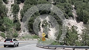 Car on Road Under Hills of Big Bear Mountain, California USA