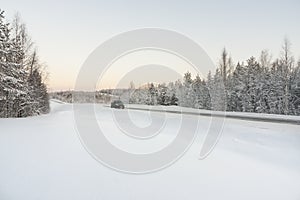 Car in the road, winter at dawn