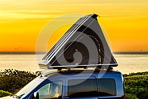 Car with roof top tent camp on beach