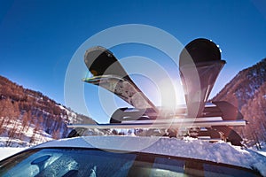 Car roof with two pairs of skis on the rack photo