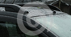 car roof and windshield with water drops after rain