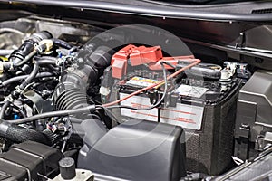 Car Rubber pipes and hoses leading from the car radiator to the engine with battery charger