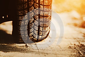 A car with rubber tires stands on a sandy road. Off-road driving. Journey