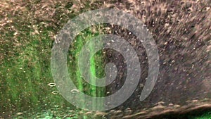 Car running through automatic carwash. Windscreen view from inside.