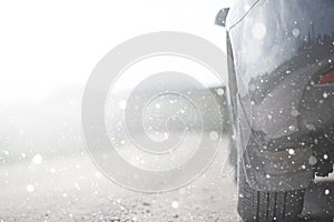 A car on a rural road in the first autumn snow. The first winter