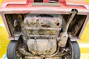 Car with rusty, damaged, corroded undercarriage at workshop for