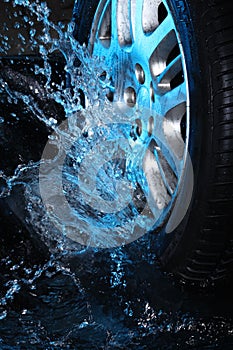 Car's wheel with blue water