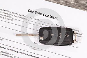 Car sale contract and car key. Sales, purchases of vehicle