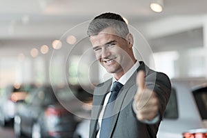 Car salesman giving a thumbs up