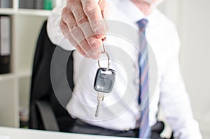 Car salesman holding a key