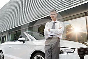 Car salesman posing at the showroom