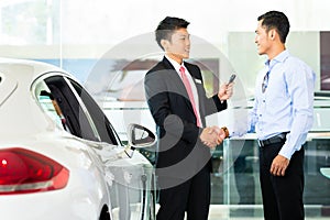 Car Salesman selling auto to customer