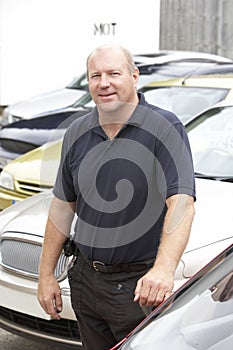 Car salesman standing on lot photo