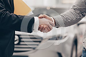 Car salesman working with a customer at the dealership