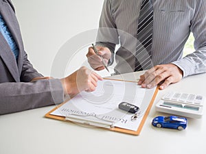 Car saleswoman giving a car rental service lease contract to customer and signed