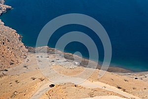 Car on the sand road at Fjord Khor Najd in Oman